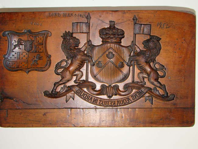 An 18th century incised carved fruitwood composition mold bearing the arms and crest of the Berkeley family dated 1754.   